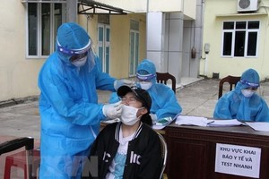 Nhân viên y tế lấy mẫu xét nghiệm. (Ảnh: Văn Tý/TTXVN).