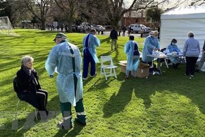 Nhân viên y tế lấy mẫu xét nghiệm COVID-19. (Ảnh: AFP/TTXVN).