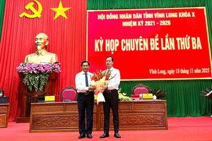 Bí thư Tỉnh ủy Vĩnh Long Trần Văn Lâu tặng hoa chúc mừng ông Trần Trí Quang (bên phải). Ảnh: Lê Sơn