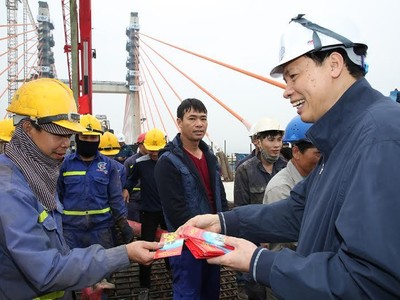Chủ tịch UBND tỉnh Quảng Ninh trò chuyện, chúc Tết công nhân thi công dự án cầu Bạch Đằng ngày 30 Tết. Ảnh: Đỗ Phương