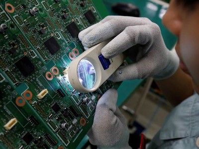 Một công nhân soát lỗi sản phẩm tại nhà máy ở Bắc Ninh, Việt Nam. (Ảnh: Reuters).