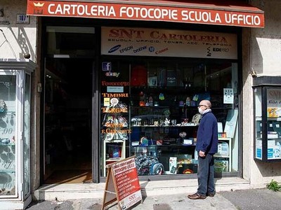 Người dân đứng trước một cửa hàng ở thành phố Catania, Italy hôm nay, sau khi chính phủ cho phép một số nơi mở cửa lại. Ảnh: Reuters.