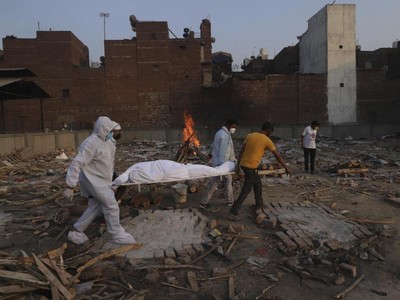 Các thành viên gia đình và tình nguyện viên mang thi thể của một bệnh nhân tử vong do Covid-19 đi hỏa táng ở New Delhi, Ấn Độ. Ảnh: AP.