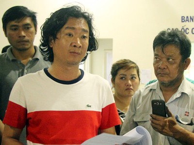 Đại diện đơn vị vận hành chung cư (trái) đưa ra thông báo xin lỗi cư dân. Ảnh:Duy Trần.