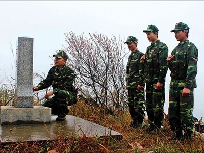 Các chiến sĩ biên phòng đứng trước cột mốc thiêng liêng của Tổ quốc trong một buổi tuần tra giáp Tết 