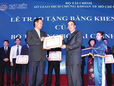 Đại diện Coteccons (trái) đón nhận Bằng khen do có nhiều thành tích đóng góp xây dựng và phát triển TTCK, ngày 25/7/2015