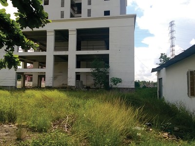 Mặc dù đã xây dựng xong phần thô, nhưng Chung cư Gia Phú vẫn nằm bất động để cỏ mọc nhiều năm nay. Ảnh: Việt Dũng