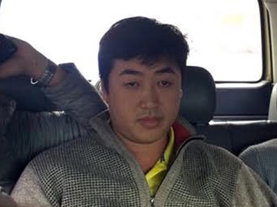 Tâm bị cảnh sát áp giải. Ảnh: Q.T