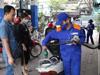 Nhân viên Petrolimex đang bán xăng cho khách hàng. (Ảnh: Đức Duy/Vietnam+)