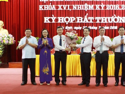 Tân Chủ tịch HĐND tỉnh Thái Bình Nguyễn Hồng Diên (thứ 3 bên phải) tặng hoa cho tân Chủ tịch UBND tỉnh Đặng Trọng Thăng (thứ 3 bên trái).