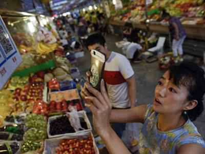 Một khách hàng Trung Quốc đang quét mã QR để thanh toán. Ảnh: VCG.