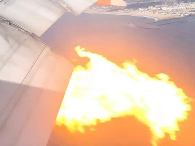 Động cơ chiếc Boeing 777 bị cháy nhìn từ cửa sổ máy bay - Ảnh: REUTERS