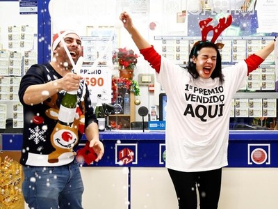 Hai chủ nhân của một gian hàng bán vé số mở rượu ăn mừng khi kết quả giải xổ số El Gordo được công bố ngày 22/12. Ảnh: Reuters.