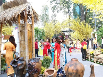 Các bạn trẻ chụp ảnh tại Lễ hội Tết Việt với nét mộc mạc của làng quê, hay một góc Sài Gòn xưa. (Ảnh: Thanh Vũ - TTXVN).