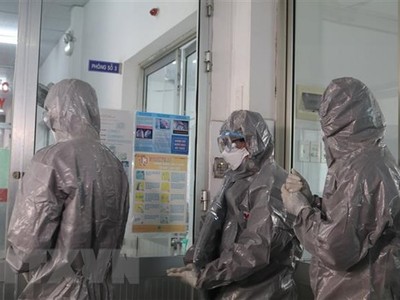 Các bác sỹ Bệnh viện Chợ Rẫy Thành phố Hồ Chí Minh mặc trang phục bảo hộ trước khi vào khu vực cách ly bệnh nhân. (Ảnh: Đinh Hằng/TTXVN).