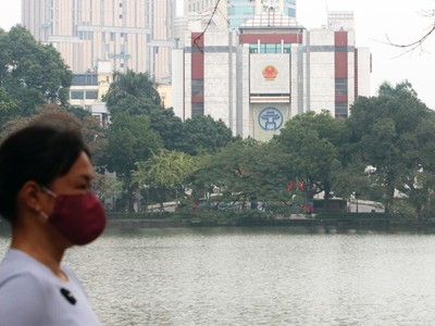 Người dân đeo khẩu trang phòng Covid-19 khi dạo quanh Hồ Gươm. 