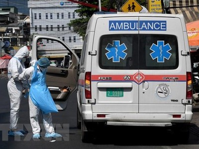 Nhân viên y tế và xe cứu thương được huy động để chuyển bệnh nhân COVID-19 tại Phnom Penh, Campuchia ngày 19/3/2021. (Ảnh: AFP/TTXVN).