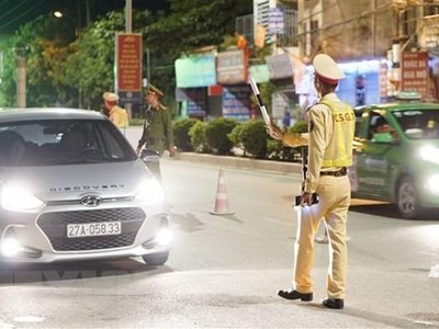 Cảnh sát giao thông dừng phương tiện để kiểm tra nồng độ cồn đối với các lái xe. (Ảnh: Xuân Tư/TTXVN).