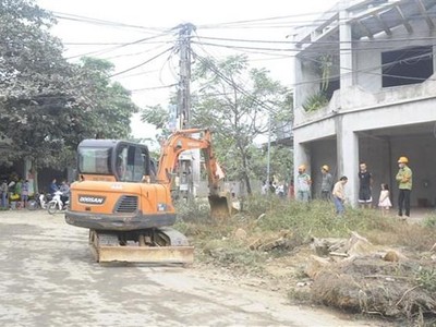Huyện Ba Vì (Hà Nội) huy động phương tiện cơ giới thực hiện cưỡng chế tháo dỡ, cây, tường rào...trong phạm vi giải phóng mặt bằng. (Ảnh Mạnh Khánh/TTXVN).