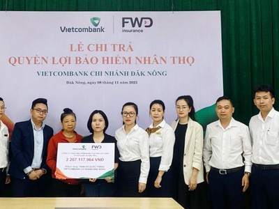 Đại diện Vietcombank Đăk Nông và FWD thực hiện chi trả quyền lợi bảo hiểm cho khách hàng