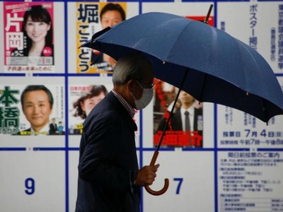 Cử tri di chuyển qua khu vực trưng bày áp phích danh sách các ứng viên cho Hội đồng Thủ đô Tokyo gần điểm bỏ phiếu vào ngày 4/7. Ảnh: Reuters