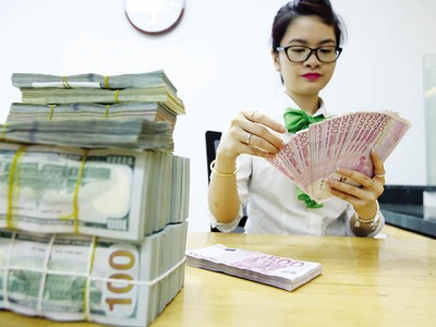 Việt Nam có nhiều lợi thế để ổn định tỷ giá, như xuất siêu ở mức cao, dự trữ ngoại hối và nguồn kiều hối lớn… Ảnh: Đ.T 