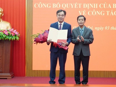 Bí thư Tỉnh ủy Quảng Trị Nguyễn Văn Phương trao quyết định và tặng hoa ông Nguyễn Lương Bình (trái ảnh). Ảnh: Linh Việt