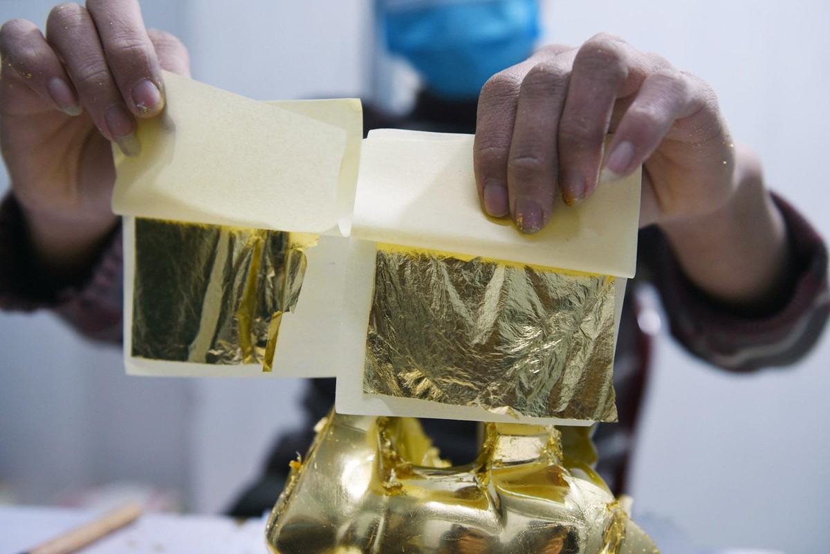 2 lá vàng 24K đang chuẩn bị được dát vào thân tượng. 2 lá vàng 24K đang chuẩn bị được dát vào thân tượng.