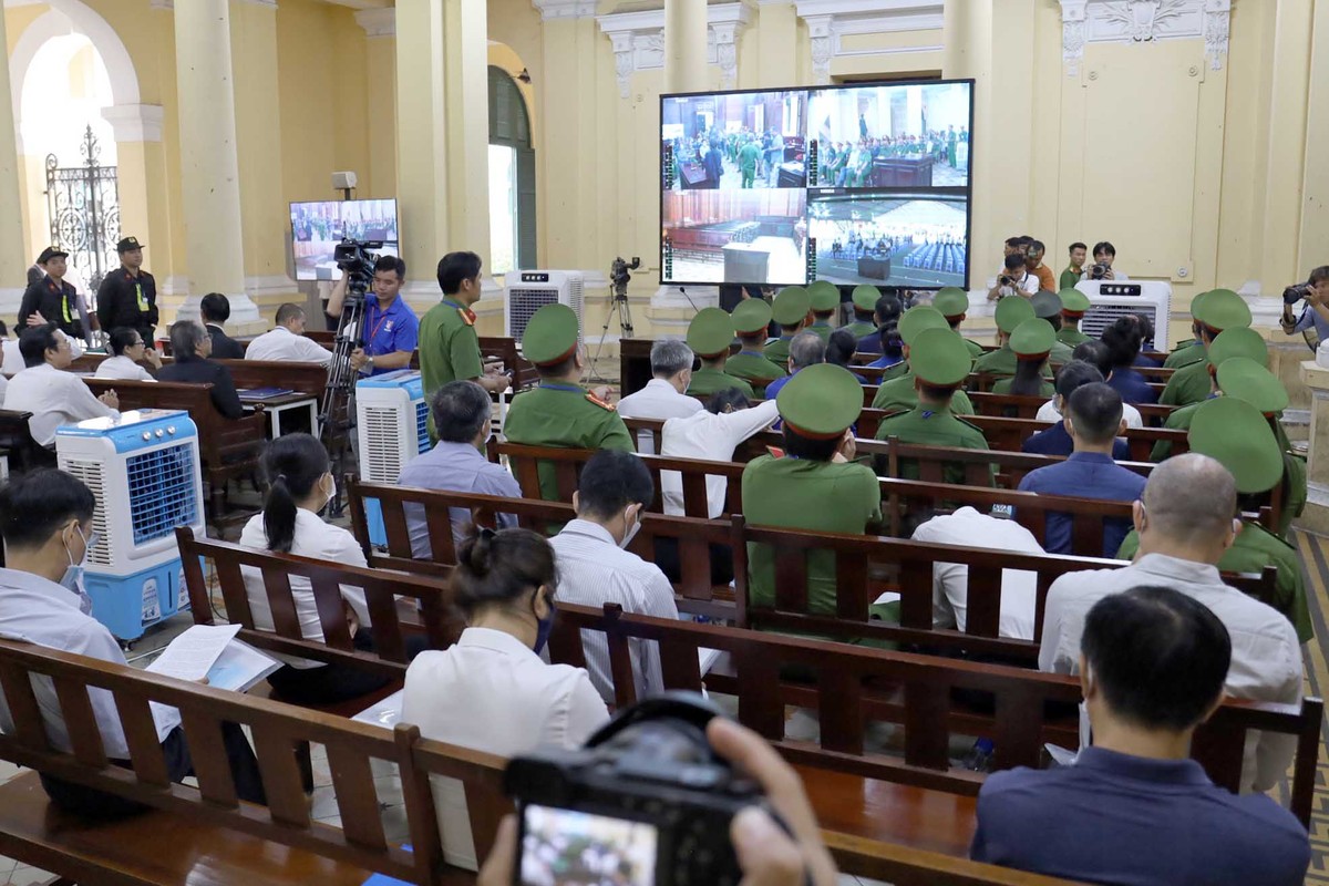 Các bị cáo theo dõi phiên toà thông qua màn hình bên ngoài phòng xét xử.