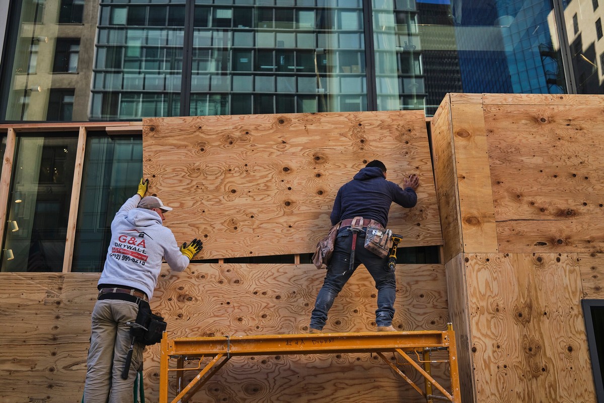 Các công nhân dựng rào chắn các ô cửa tại Manhattan Các công nhân dựng rào chắn các ô cửa tại Manhattan