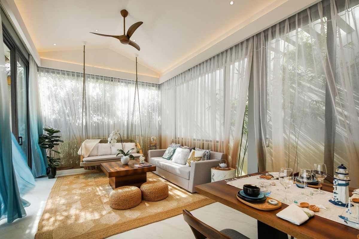 Tôn trọng tối đa thiên nhiên, không gian trong biệt thự được thiết kế với hệ thống kính lớn như xóa nhòa ranh giới bên trong và bên ngoài. Trải nghiệm nghỉ dưỡng sẽ thêm ý nghĩa khi cả gia đình cùng quây quần trong phòng sinh hoạt chung, nhâm nhi ly cocktail và ngắm thiên nhiên, biển trời, mây gió, lắng nghe tiếng sóng vỗ êm đềm đặc trưng của vùng biển đảo An Thới tràn qua cánh cửa… Xúc cảm được đánh thức, mọi bộn bề trong cuộc sống bỗng chốc tan biến, chỉ còn lại sự thảnh thơi, thư giãn được nâng niu tuyệt đối.