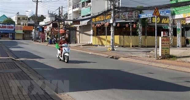 Người đi giao hàng cho các hộ dân theo khung giờ khu vực đường Đình Phong Phú, thành phố Thủ Đức, Thành phố Hồ Chí Minh. (Ảnh: Hồng Nhung/TTXVN)