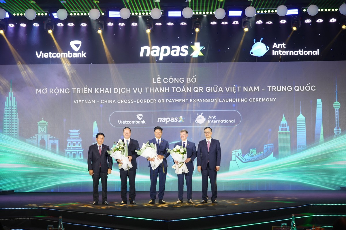 Các Phó Thống đốc Ngân hàng Nhà nước Việt Nam gồm ông Phạm Tiến Dũng và ông Phạm Quang Dũng tặng hoa chúc mừng lãnh đạo NAPAS, Vietcombank và Ant International.