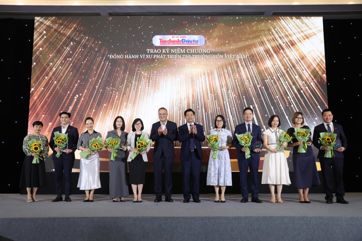 Đại diện các công ty nhận kỷ niệm chương chụp ảnh lưu niệm với ông Bùi Hoàng Hải ,Phó Chủ tịch UBCK Nhà nước và ông Phạm Văn Hoành, Tổng Biên tập Báo Tài chính - Đầu tư.