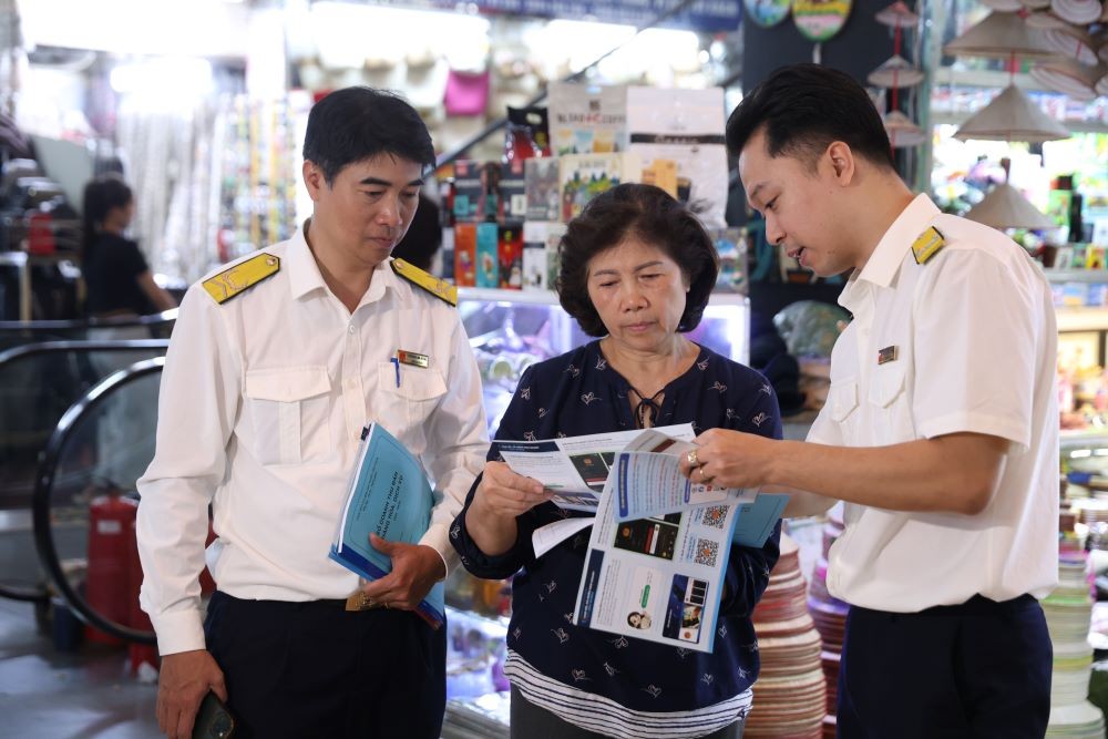 Công chức thuế hướng dẫn hộ kinh doanh kê khai thuế theo quy định mới.