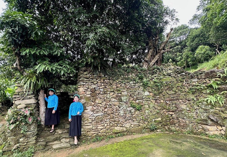 Những cô gái người Sán Chỉ đón khách vào tham quan nhà cổ của dân tộc mình. Ảnh: Thanh Tân