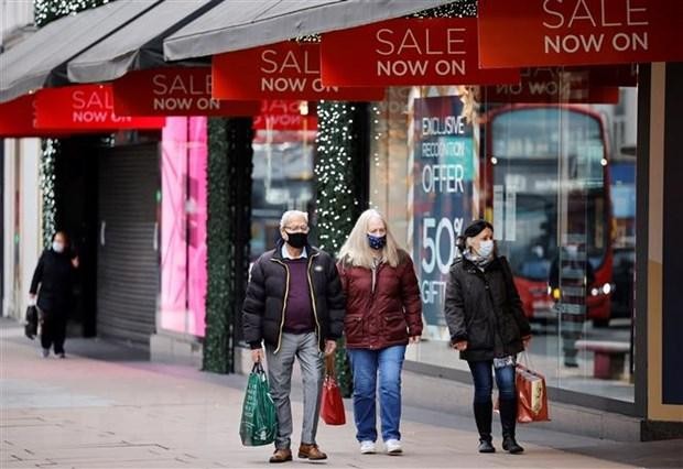 Người dân di chuyển trên một phố mua sắm ở London, Anh. (Ảnh: AFP/TTXVN) Người dân di chuyển trên một phố mua sắm ở London, Anh. (Ảnh: AFP/TTXVN)