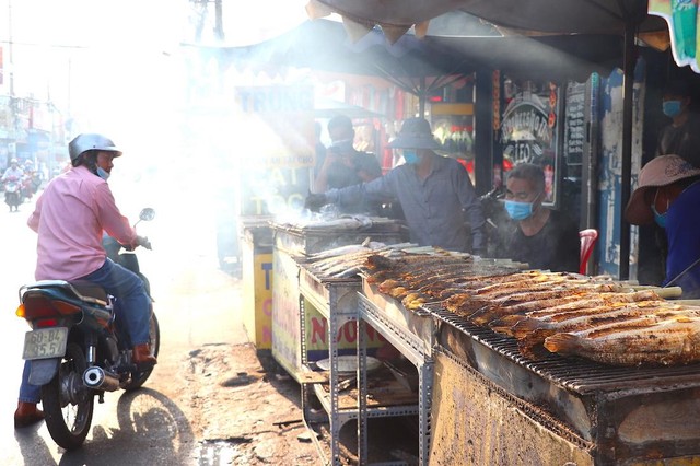 Khách chọn mua cá lóc nướng cúng ngày vía Thần Tài, cầu mua may bán đắt, công việc làm ăn thuận lợi và phát triển (Ảnh: T. Hồng).