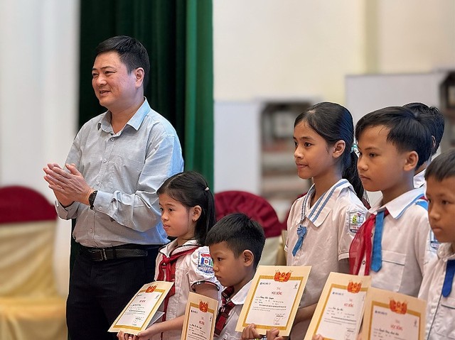 Tiến sỹ Ngô Trung Hà, Hiệu trưởng Trường Cao đẳng Quốc tế Pegasus (thuộc Tập đoàn Giáo dục Quốc tế KinderWorld) trao giấy chứng nhận và học bổng cho các em học sinh.