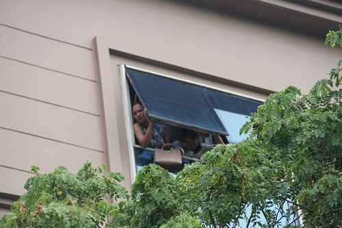 Nhân viên mắc kẹt tại tầng 5 mở cửa sổ kêu cứu. Ảnh: Gia Chính.