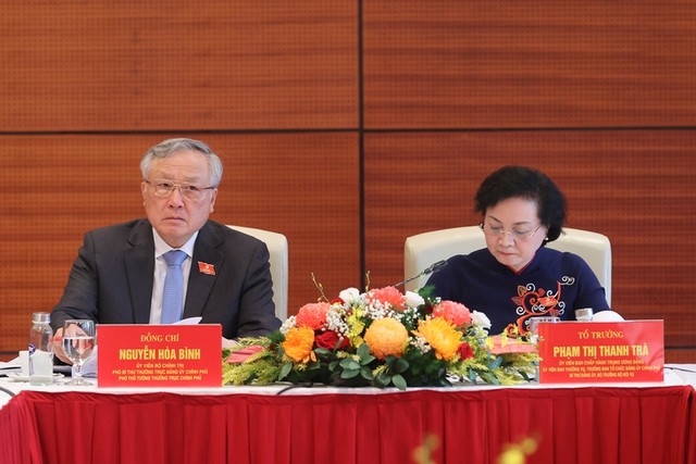 Phó Thủ tướng Thường trực Chính phủ Nguyễn Hòa Bình và Bộ trưởng Bộ Nội vụ Phạm Thị Thanh Trà thảo luận tại tổ về các văn kiện Đại hội và dự thảo các văn kiện trình Đại hội XIV của Đảng - Ảnh: VGP/Nhật Bắc