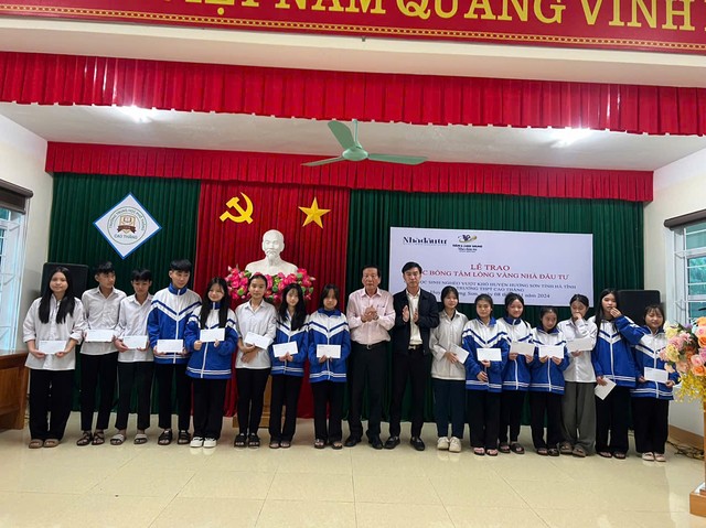 TS. Nguyễn Anh Tuấn và nhà báo Nguyễn Văn Dũng, quyền Trưởng VPĐD Tạp chí Nhà đầu tư tại Bắc Trung Bộ trao học bổng cho các em học sinh trường THPT Cao Thắng. Ảnh: Trương Hoa.