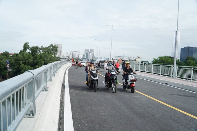 Người dân đi lại trên cầu Rạch Đỉa mới. Ảnh: Lê Vinh