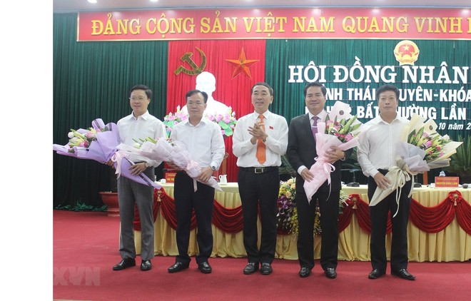 Bí thư Tỉnh ủy Thái Nguyên Trần Quốc Tỏ (người ở giữa) tặng hoa chúc mừng Phó Chủ tịch tỉnh và các Ủy viên UBND tỉnh mới được bầu tại kỳ họp. (Ảnh: Hoàng Nguyên/TTXVN)