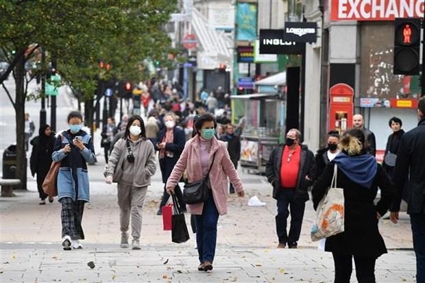 Người dân đeo khẩu trang phòng dịch COVID-19 tại London, Anh. (Ảnh: AFP/TTXVN).