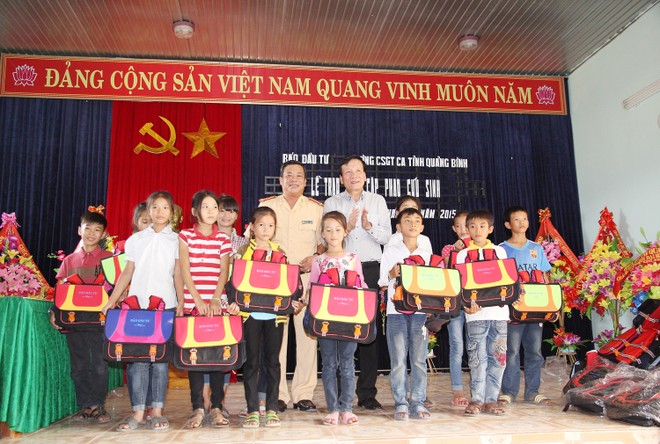 Ông Nguyễn Anh Tuấn, Tổng biên tập Báo Đầu tư và ông Võ Văn Chính, Phó Trưởng phòng Cảnh sát giao thông tỉnh Quảng Bình trao cặp phao cứu sinh cho học sinh xã Quảng Minh.