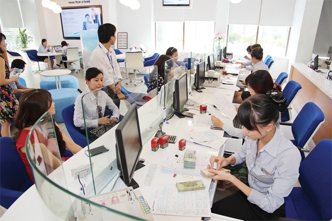 Đến cuối tháng 11/2014, lãi suất huy động và cho vay bằng VND đã giảm 1,5 - 2,0%/năm so với cuối năm 2013
