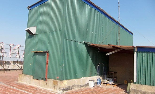 Mô tơ thang máy Tòa nhà Sakura được quây bao thô sơ bằng tôn. 
ảnh: Phương Anh