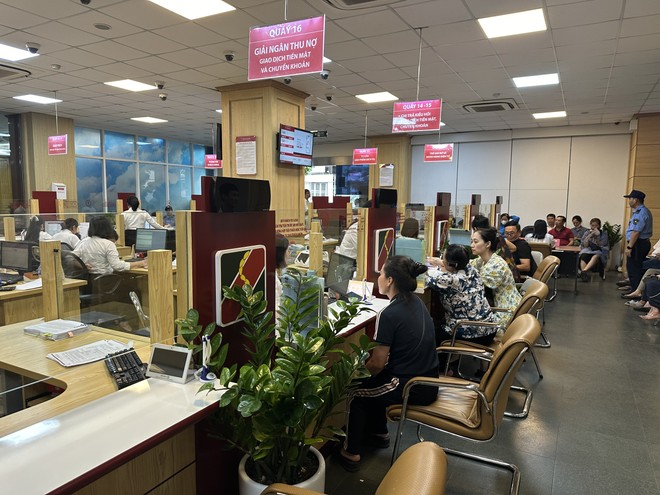 Người dân mua vàng miếng SJC tại một trong những điểm bán vàng của ngân hàng thương mại có vốn nhà nước.