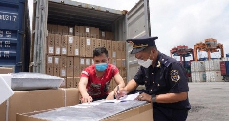 Công chức hải quan kiểm soát hàng hóa xuất nhập khẩu. (Ảnh: Bùi Nụ)
